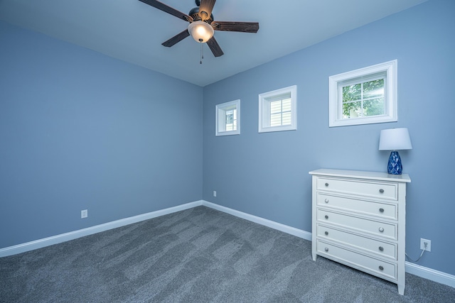 1721 Wellstead St, Mount Pleasant, SC 29466 - unfurnished bedroom with multiple windows, dark carpet, and a ceiling fan