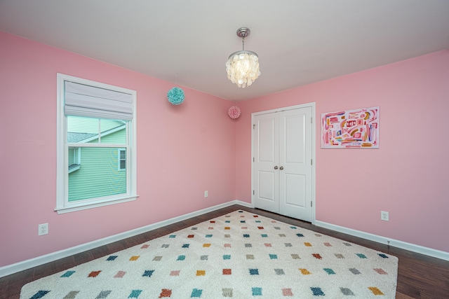 1721 Wellstead St, Mount Pleasant, SC 29466 - unfurnished bedroom featuring dark wood-style flooring, a chandelier, and a closet