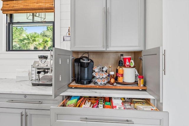 details featuring white cabinetry and light stone counters