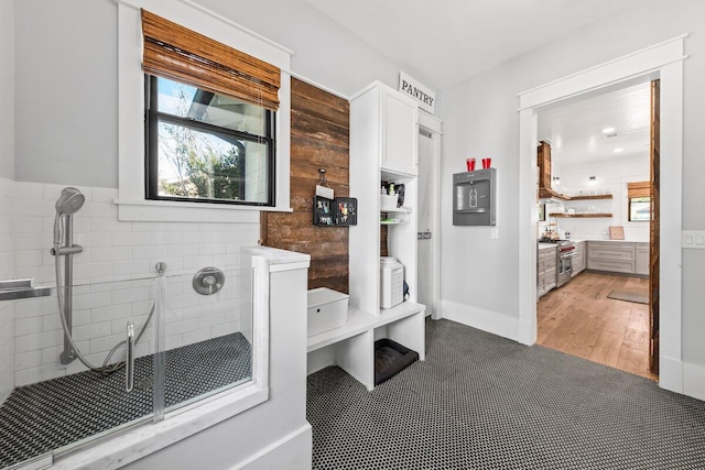 bathroom featuring tile walls and wood-type flooring