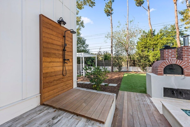 wooden terrace with a lawn