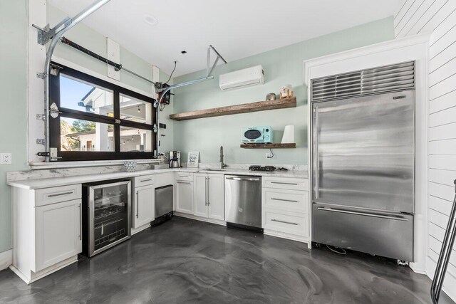 kitchen with white cabinets, stainless steel appliances, a wall mounted air conditioner, and wine cooler