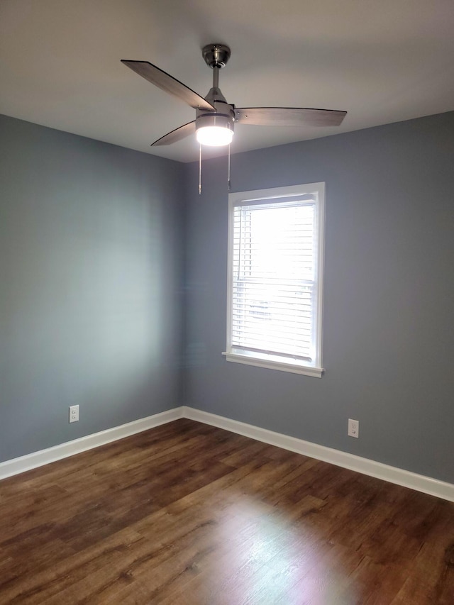 unfurnished room with ceiling fan and dark hardwood / wood-style flooring