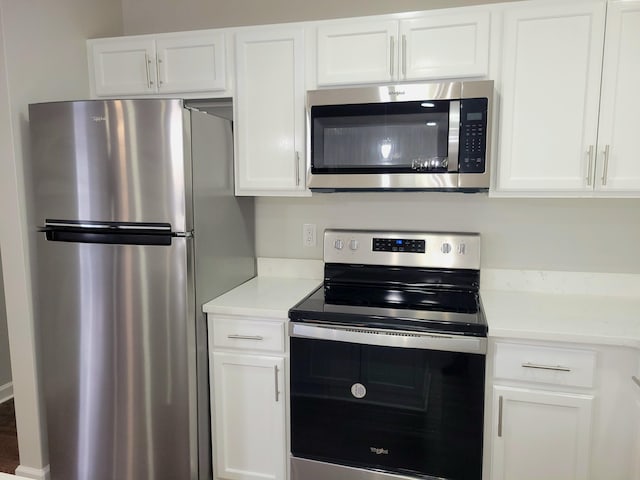 kitchen featuring appliances with stainless steel finishes and white cabinets