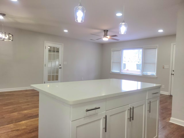 kitchen featuring hanging light fixtures, white cabinetry, and dark hardwood / wood-style flooring