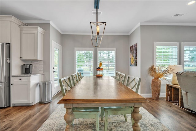 dining area with dark wood-style floors, visible vents, plenty of natural light, and ornamental molding