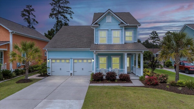 view of front of house featuring a porch, an attached garage, a front yard, a shingled roof, and driveway