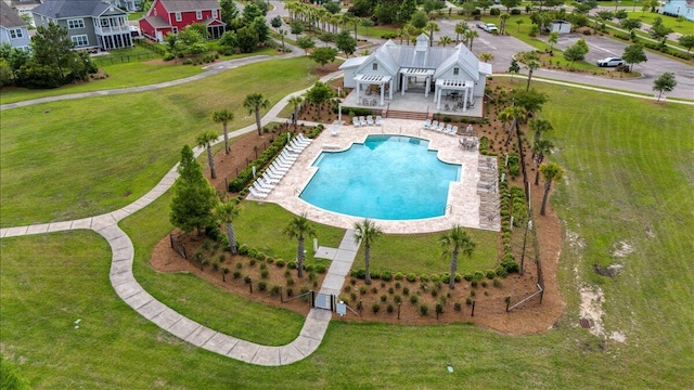 community pool with a pergola, a patio area, and a residential view