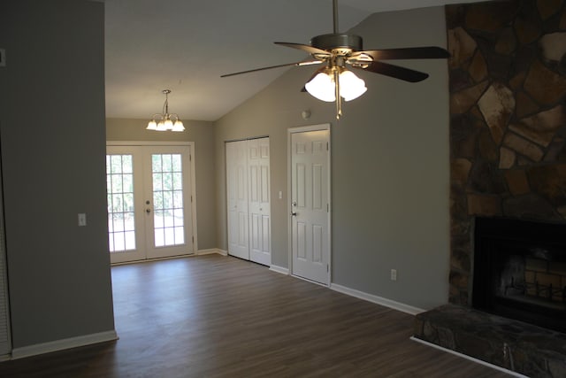 unfurnished living room with french doors, a fireplace, dark hardwood / wood-style floors, and vaulted ceiling