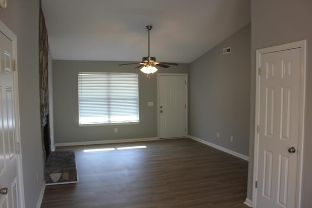 unfurnished living room featuring vaulted ceiling, ceiling fan, and dark hardwood / wood-style flooring