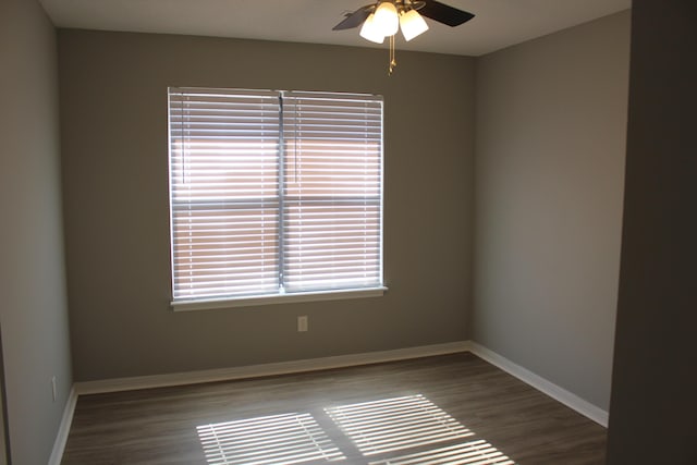 empty room with dark wood-type flooring and ceiling fan