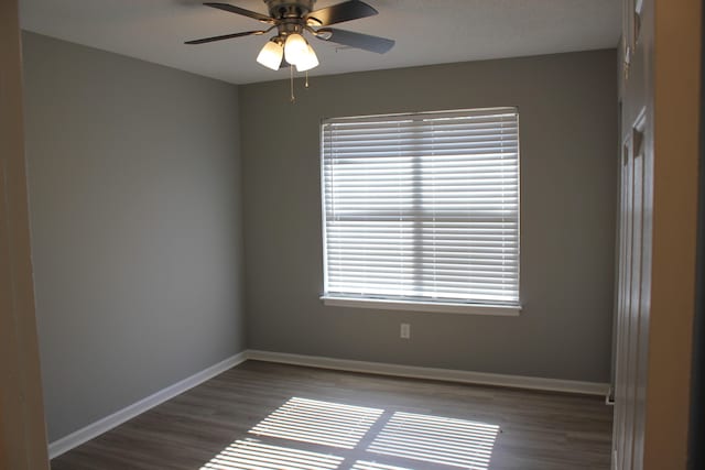 spare room featuring ceiling fan and dark hardwood / wood-style flooring