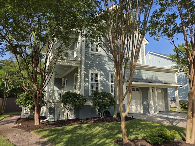 133 Wando Reach Rd, Wando, SC 29492 - view of front facade featuring a balcony, an attached garage, a front yard, driveway, and covered porch