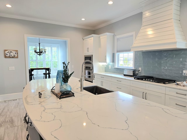133 Wando Reach Rd, Wando, SC 29492 - kitchen featuring stainless steel gas stovetop, custom exhaust hood, a sink, a chandelier, and recessed lighting
