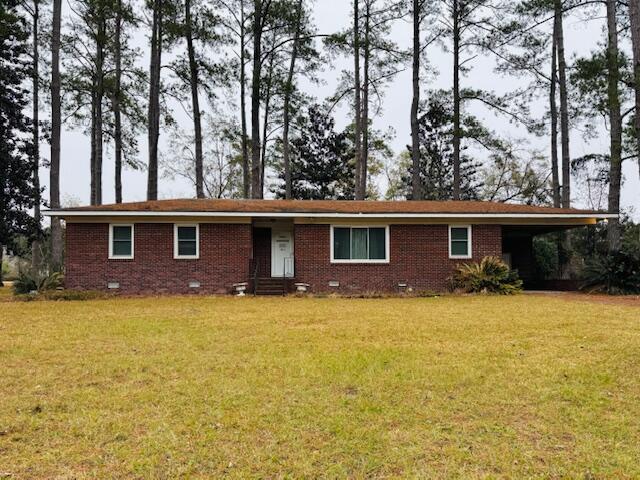 view of front of house with a front lawn and a carport