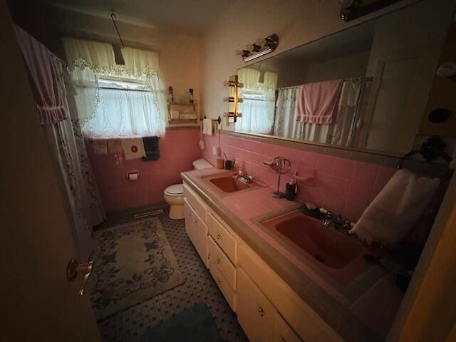 bathroom featuring tasteful backsplash, vanity, and toilet