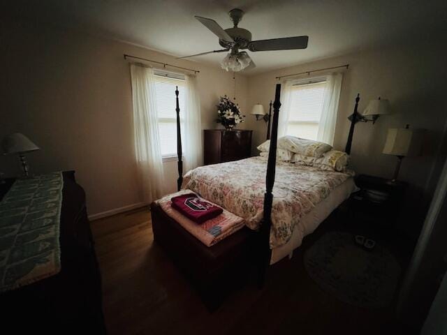 bedroom with ceiling fan and dark hardwood / wood-style floors