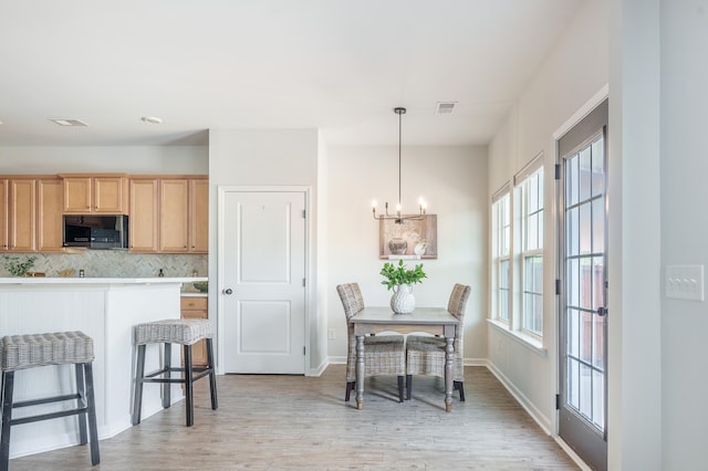 743 Redbud Ln, Summerville, SC 29486 - dining area with a chandelier, light wood-type flooring, and baseboards