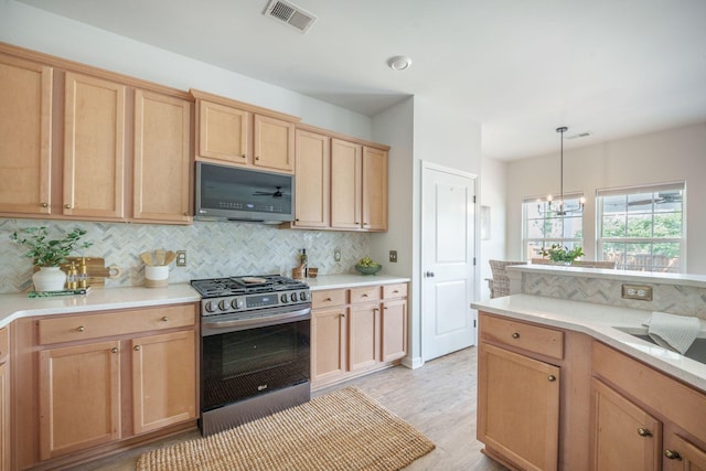 743 Redbud Ln, Summerville, SC 29486 - kitchen with stainless steel range with gas cooktop, decorative backsplash, light countertops, light wood-style floors, and pendant lighting