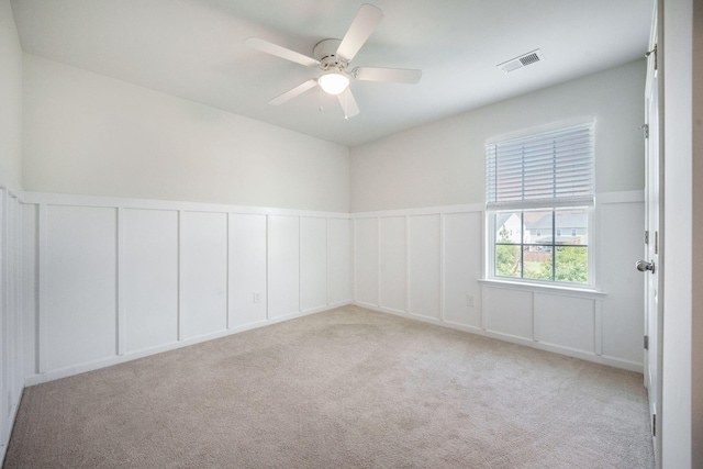 743 Redbud Ln, Summerville, SC 29486 - carpeted empty room featuring a decorative wall, ceiling fan, and wainscoting