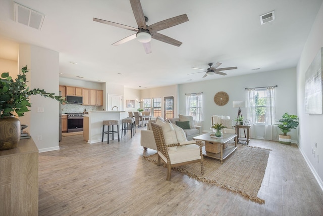 743 Redbud Ln, Summerville, SC 29486 - living area featuring a ceiling fan, light wood-style floors, and baseboards