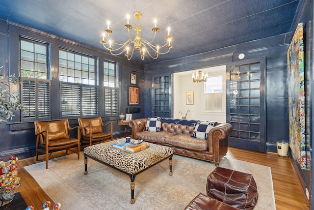 living room with hardwood / wood-style floors and a chandelier