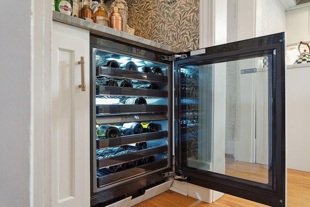 bar with hardwood / wood-style floors