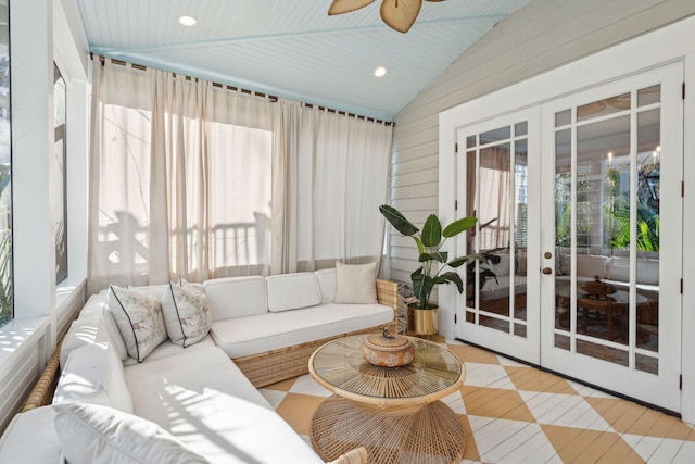 sunroom / solarium featuring french doors, ceiling fan, and vaulted ceiling