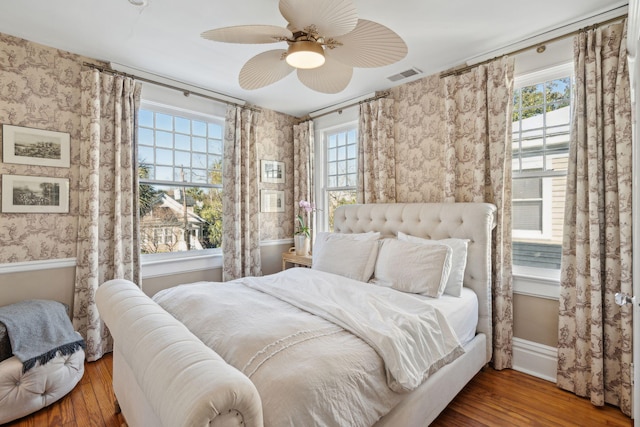 bedroom with wood-type flooring and ceiling fan