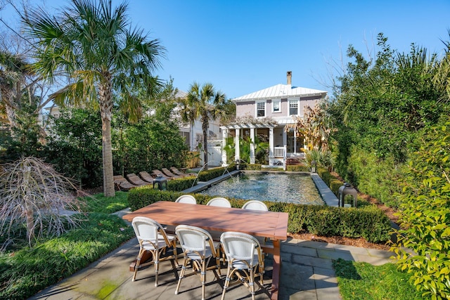 rear view of house with a pergola and a patio