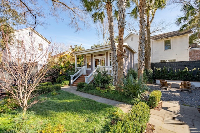 view of front of property with a front lawn and an outdoor fire pit