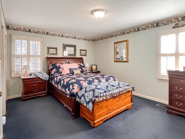 carpeted bedroom featuring a textured ceiling