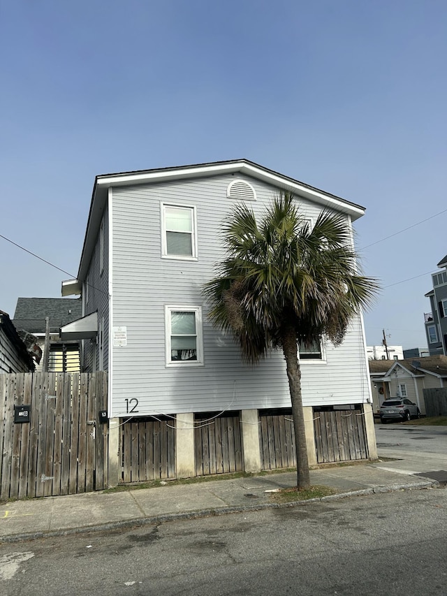 view of side of home featuring fence