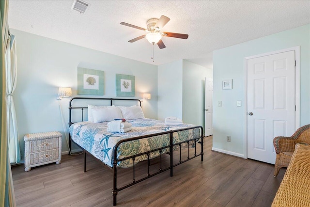 bedroom featuring a textured ceiling, ceiling fan, and wood-type flooring