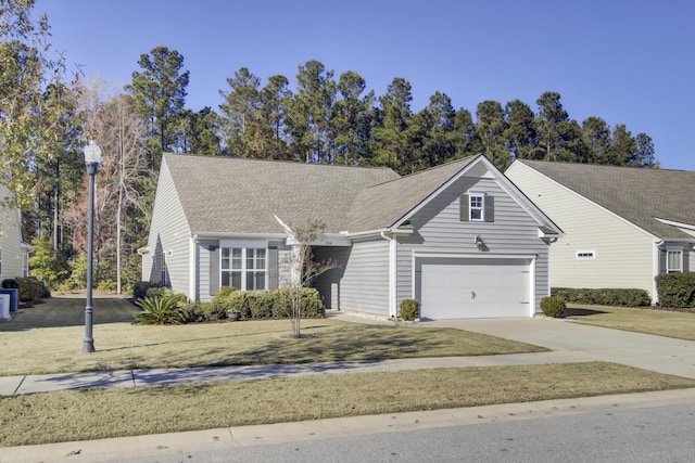 view of front of house featuring driveway, roof with shingles, and a garage