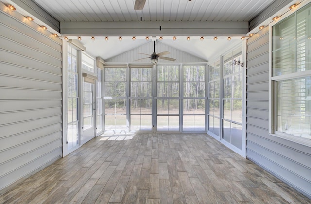unfurnished sunroom with wood finished floors, vaulted ceiling with beams, and ceiling fan