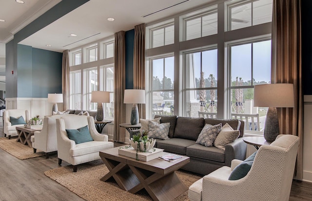 living area with a high ceiling, dark wood-style flooring, and recessed lighting