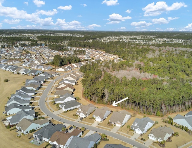 birds eye view of property with a view of trees and a residential view