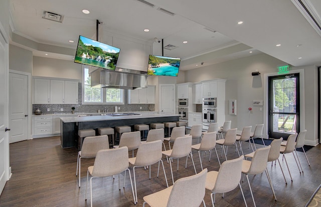 kitchen with recessed lighting, tasteful backsplash, white cabinetry, and a kitchen island