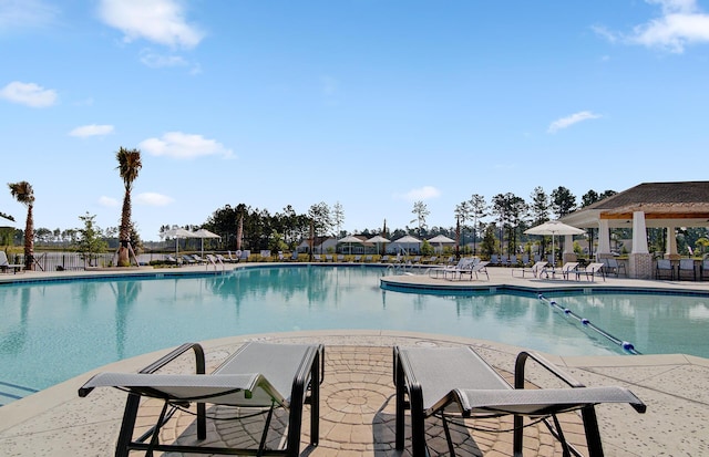 community pool featuring a patio area and fence