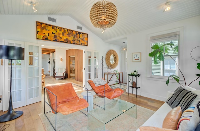 11 Francis St, Charleston, SC 29403 - living area featuring french doors, hardwood / wood-style floors, vaulted ceiling, and baseboards