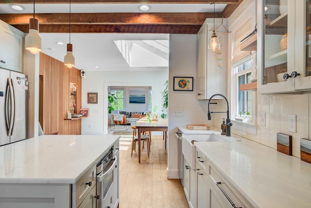 11 Francis St, Charleston, SC 29403 - kitchen featuring stainless steel appliances, a sink, beamed ceiling, light wood-style flooring, and hanging light fixtures