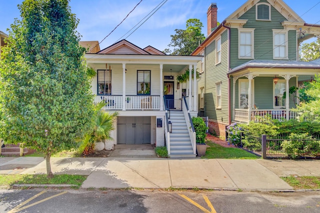 11 Francis St, Charleston, SC 29403 - view of front of home with covered porch, stairs, an attached garage, and a chimney
