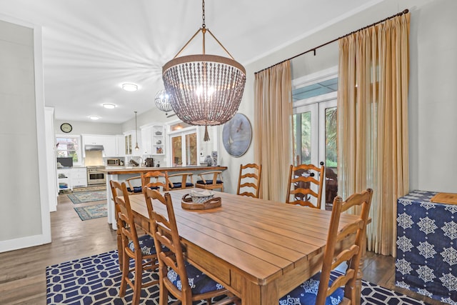 dining space featuring a chandelier, dark hardwood / wood-style flooring, and french doors