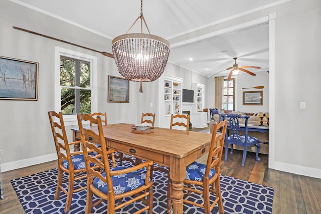 dining area with ceiling fan with notable chandelier and dark hardwood / wood-style floors