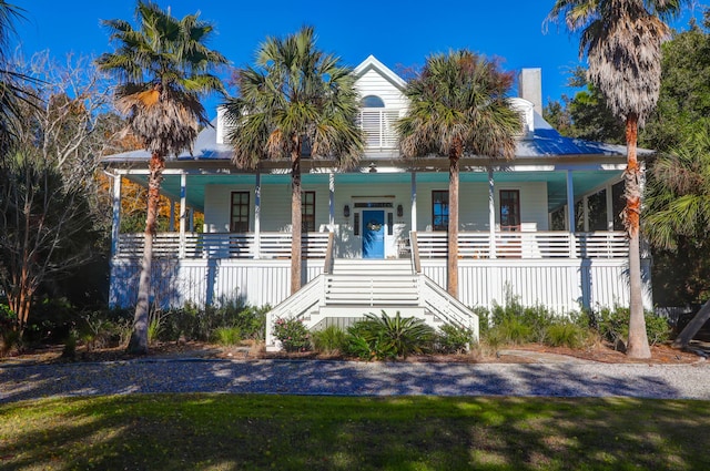 view of front facade with covered porch and a front lawn