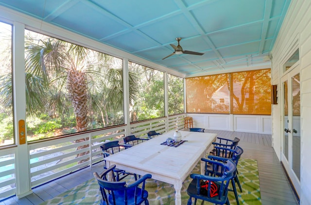 sunroom / solarium featuring ceiling fan, a healthy amount of sunlight, and coffered ceiling