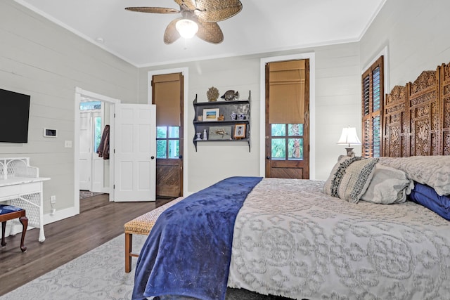 bedroom with crown molding, ceiling fan, and dark wood-type flooring