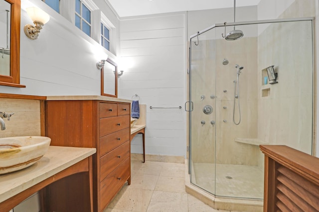 bathroom with vanity and a shower with door