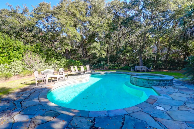 view of swimming pool with a patio area and an in ground hot tub